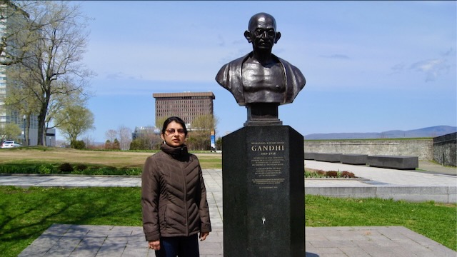 Posing next to Gandhi's bust, Place de ville, Quebec